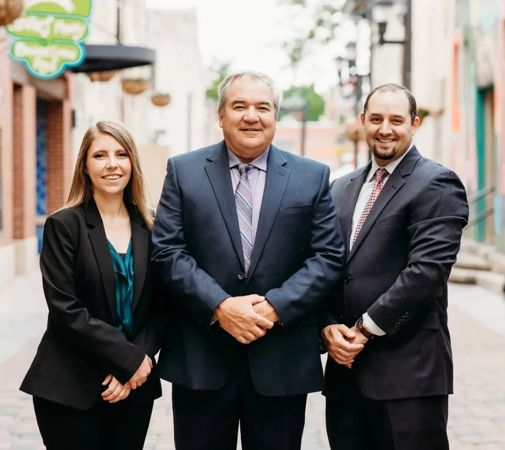 Hoffman attorneys elyse, brad, and ryan posing in old town fort collins colorado