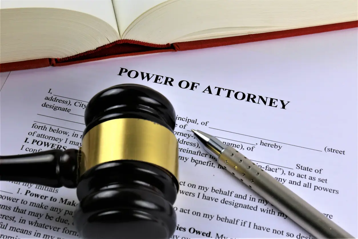 a gavel ontop of a document that reads power of attorney