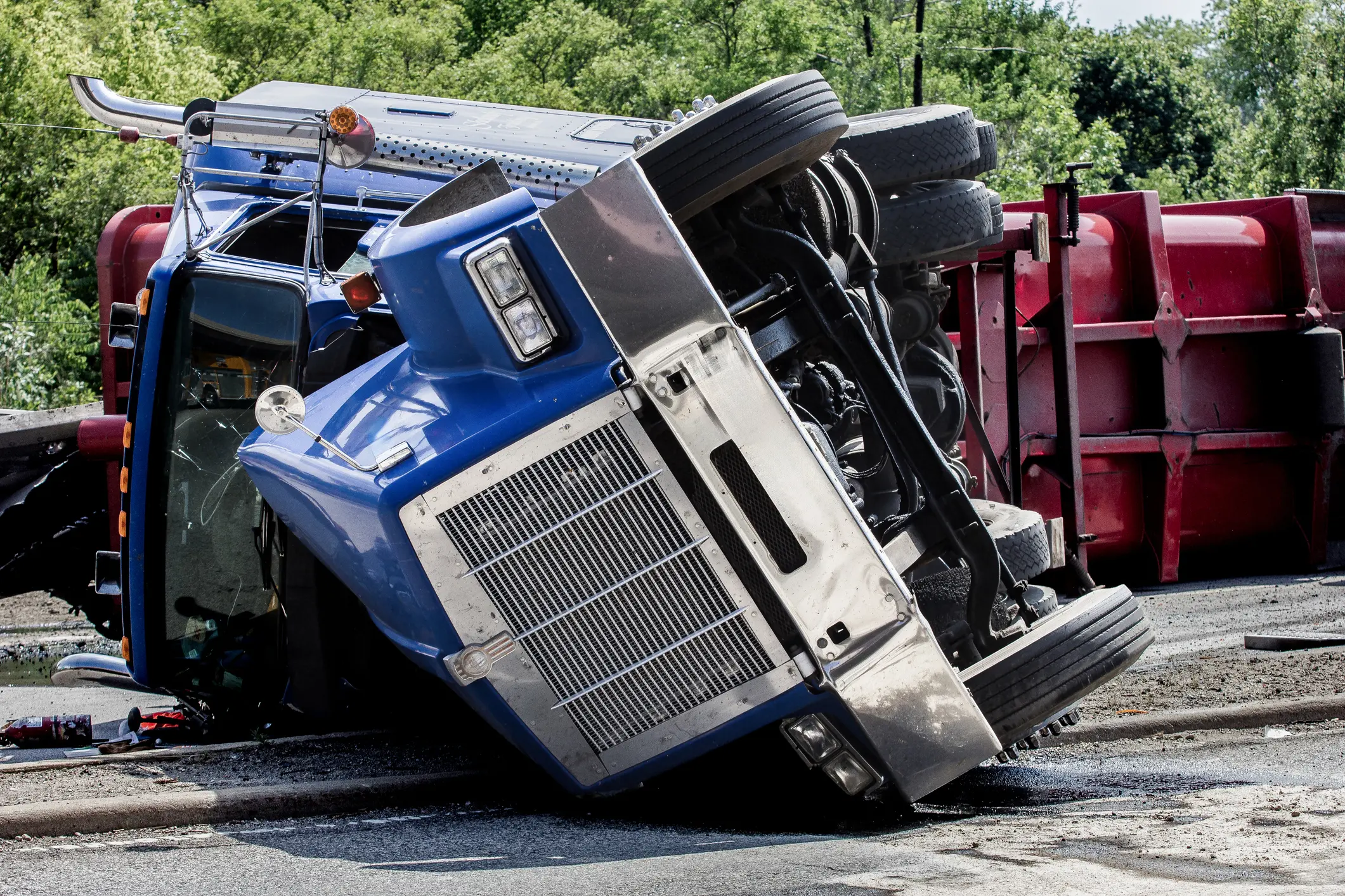 semi-truck accident in colorado with a semi-truck on its side after colliding with another vehicle during the day