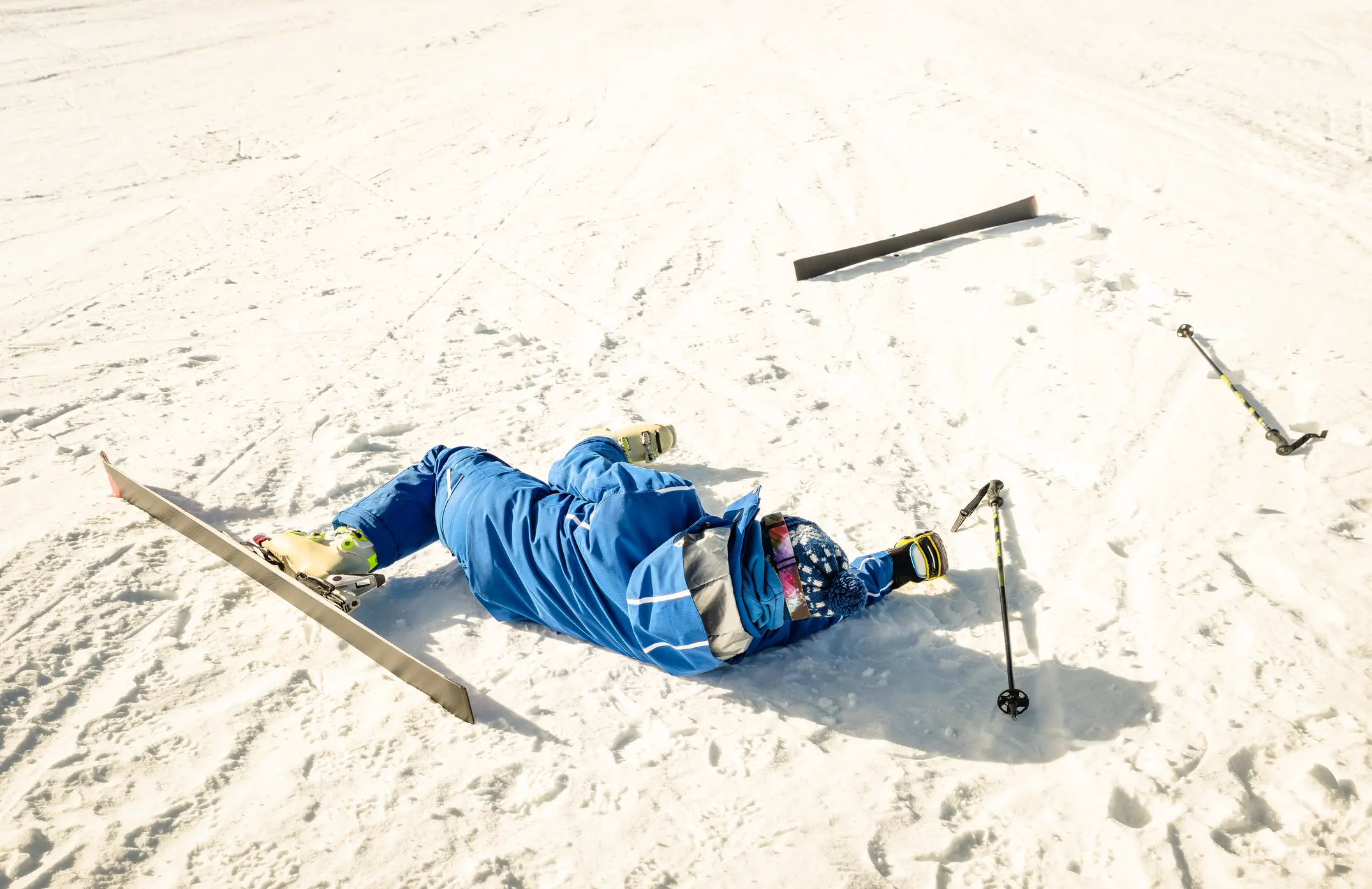 Skier laying in the snow injured.